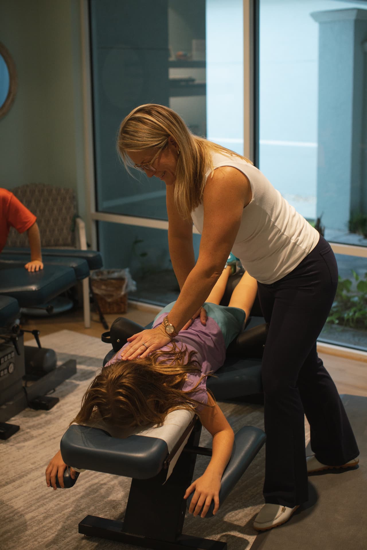 Dr. Lindsay Dodd providing gentle chiropractic care for a child in Naples, FL
